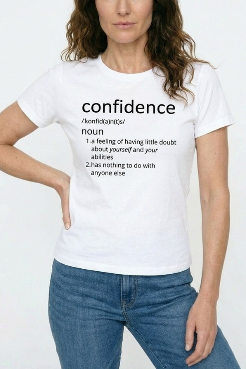 Person wearing a white t-shirt with 'confidence' definition text on a plain background