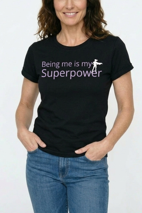 Person wearing a black t-shirt with 'Being me is my Superpower' text on a white background