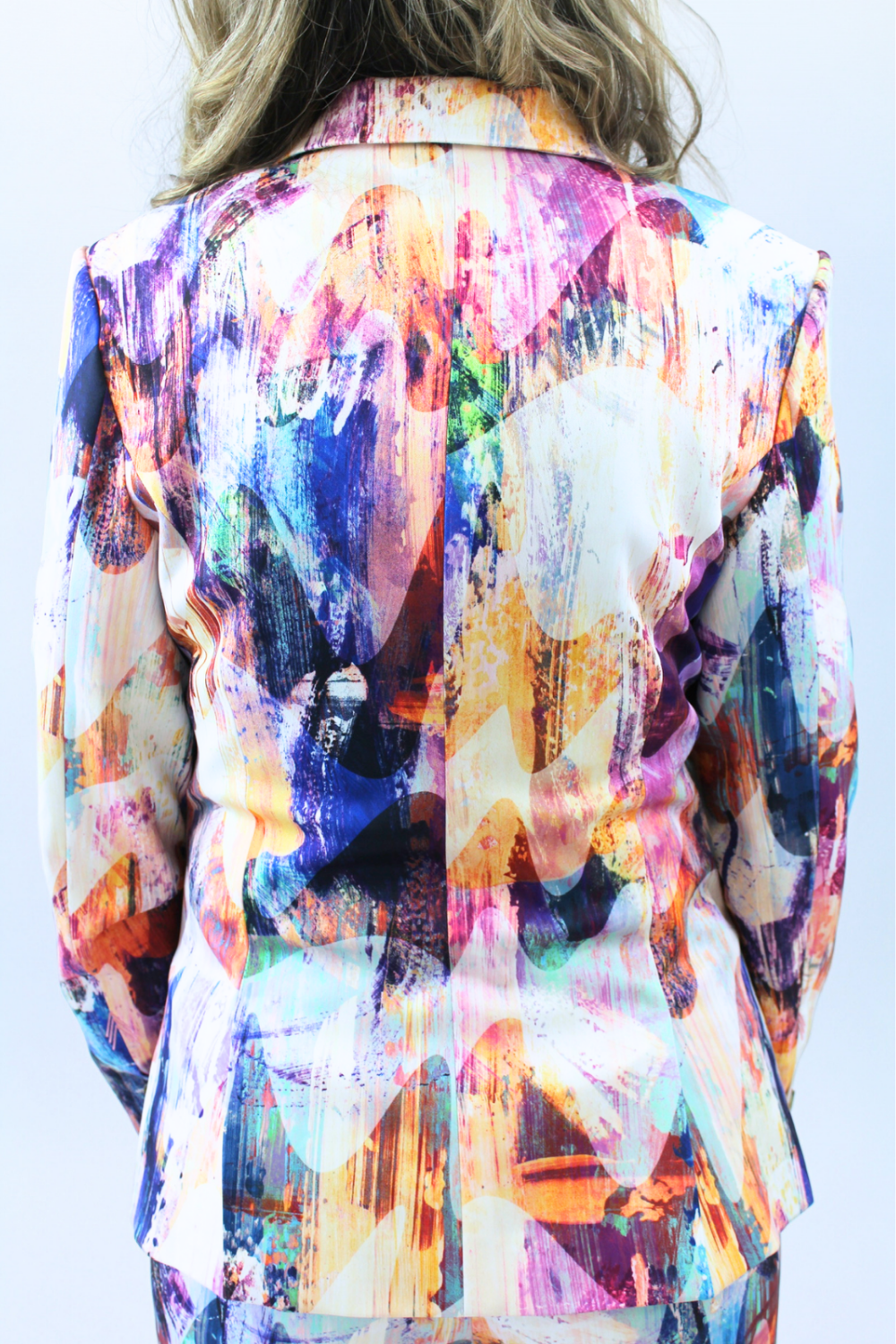 Multicolored abstract patterned jacket on a plain background