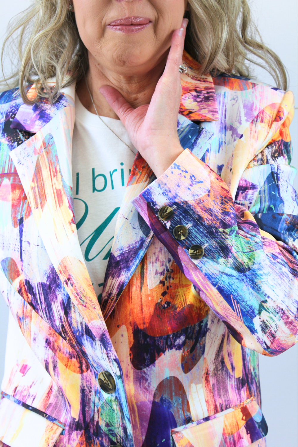 Person wearing a colorful jacket with a white shirt underneath