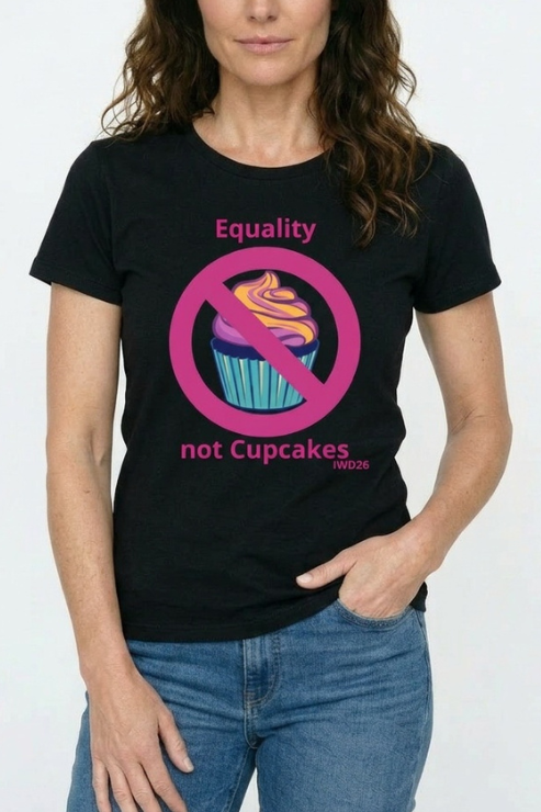 Person wearing a black t-shirt with a pink equality symbol over a cupcake graphic and text.