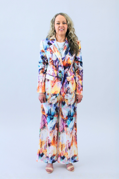 Woman wearing a colorful print outfit on a white background