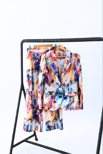 Colorful jacket on a black stand against a white background