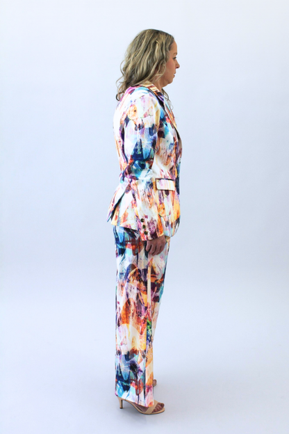 Woman wearing a colorful print suit on a white background