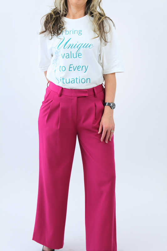 Person wearing a white t-shirt with text and pink pants on a white background