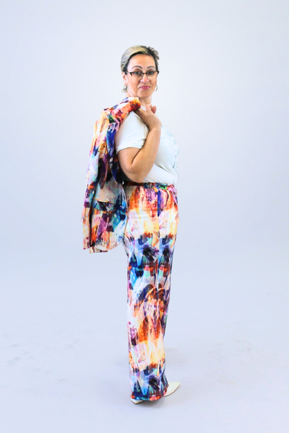 Woman wearing a colorful trousers with a white background