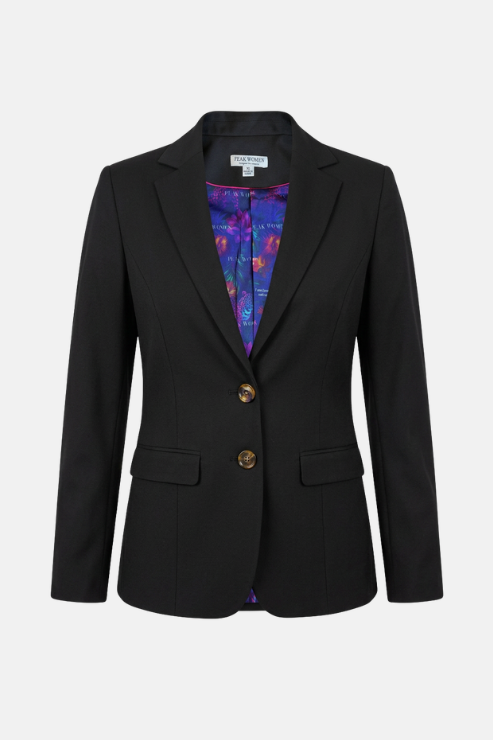 A black tailored blazer with notched lapels, two gold-tone buttons, and flap pockets, shown against a light gray background. A colorful purple and blue patterned lining is visible at the open collar.
