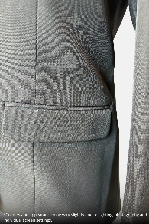 Close-up of a black blazer fabric showing a welt pocket and lapel detail, with a small white text disclaimer at the bottom left.