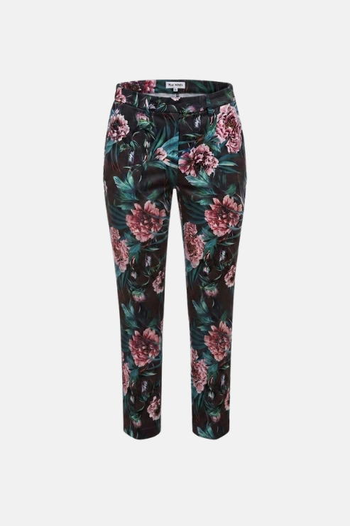 A pair of slim-fit trousers featuring a dark green and black tropical floral print with pink peony flowers, shown against a plain light gray background.