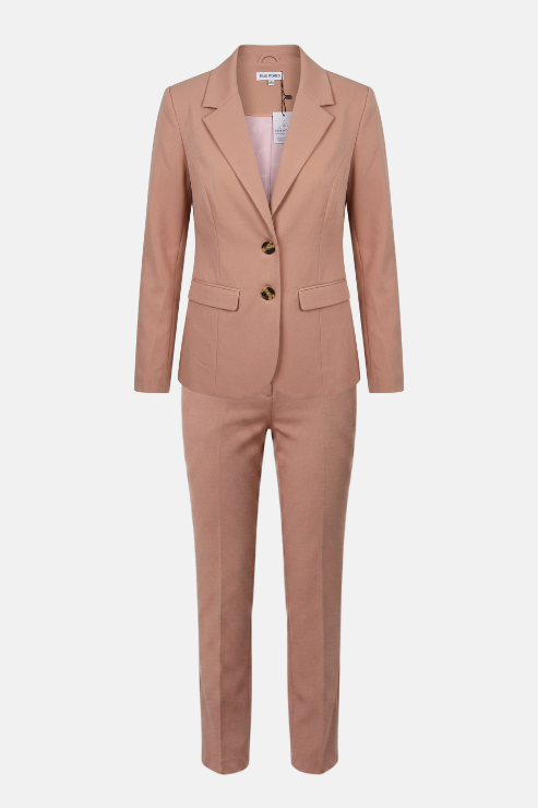 A women's two-piece suit in a dusty rose pink color, featuring a double-breasted blazer with notched lapels and matching straight-leg trousers, shown against a plain light gray background.