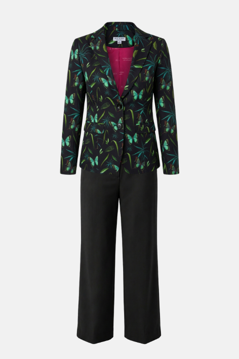 A women's two-piece suit featuring a black blazer with a vibrant green and blue butterfly pattern and a bright magenta lining, paired with solid black wide-leg trousers, shown on a light gray background.